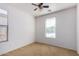 Well-lit bedroom with neutral carpeting and ceiling fan at 4548 E Carob Dr, Gilbert, AZ 85298