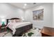 Serene bedroom with floral bedding, nightstands, and window with natural light at 8132 W Hatfield Rd, Peoria, AZ 85383