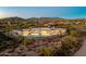Luxury home with a large pool and mountain views at dusk at 9989 E Aleka Way # 337, Scottsdale, AZ 85262
