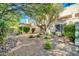 Landscaped backyard with gravel and mature trees at 7101 W Beardsley Rd # 1502, Glendale, AZ 85308