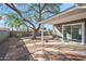 Landscaped backyard with mature tree, flagstone patio, and gravel at 1173 E Cordova Ave, Casa Grande, AZ 85122