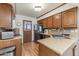 Galley kitchen with wood cabinets and laminate countertops at 455 S Delaware Dr # 1, Apache Junction, AZ 85120