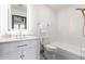 Modern bathroom with a white vanity, bathtub, and marble countertop at 8643 E San Jacinto Dr, Scottsdale, AZ 85258