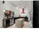 Modern kitchen with sleek cabinetry, granite island, and red range hood at 8643 E San Jacinto Dr, Scottsdale, AZ 85258