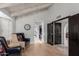 Long hallway with light wood floors and dark doors at 8643 E San Jacinto Dr, Scottsdale, AZ 85258