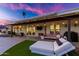 Covered patio with lounge seating, string lights, and grill at 8643 E San Jacinto Dr, Scottsdale, AZ 85258