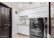 Laundry room with modern LG washer and dryer, white cabinets, and a sink at 8643 E San Jacinto Dr, Scottsdale, AZ 85258