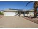 Front view of a single-story house with a two-car garage and solar panels at 12442 W Marble Dr, Sun City West, AZ 85375