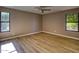 Well-lit bedroom with double windows, ceiling fan, and wood-look floors at 2511 Leisure World --, Mesa, AZ 85206