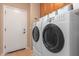 Convenient laundry room with washer, dryer, and storage at 41245 N Rolling Green Way, Anthem, AZ 85086