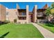 Attractive two-story condo building with grassy area and walkway at 5525 E Thomas Rd # F9, Phoenix, AZ 85018