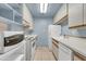 Clean galley kitchen featuring white appliances and wood cabinets at 5525 E Thomas Rd # F9, Phoenix, AZ 85018