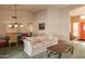 Bright dining area with southwestern-style decor and adjacent living room at 20439 N 135Th Ave, Sun City West, AZ 85375