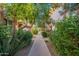 Landscaped walkway with lush greenery leads through the community at 4848 N Woodmere Fairway -- # 15, Scottsdale, AZ 85251
