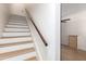 Modern staircase with wooden handrail and white risers at 4848 N Woodmere Fairway -- # 15, Scottsdale, AZ 85251