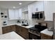 Modern kitchen with stainless steel appliances and white shaker cabinets at 4848 N Woodmere Fairway -- # 15, Scottsdale, AZ 85251