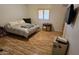 Bedroom with wood flooring, queen bed, and window with shutters at 2926 W Tanya Trl, Phoenix, AZ 85086