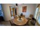Rustic dining room with a wooden table, chairs, and large window at 2926 W Tanya Trl, Phoenix, AZ 85086