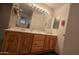 Double vanity bathroom with wood cabinets and large mirror at 2926 W Tanya Trl, Phoenix, AZ 85086