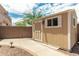 Tan storage shed with white trim and a window at 11305 S 195Th Dr, Buckeye, AZ 85326
