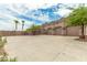 Three-car garage with stucco exterior and a large paved driveway at 11305 S 195Th Dr, Buckeye, AZ 85326