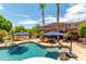 Inviting kidney shaped pool with blue umbrellas at 11305 S 195Th Dr, Buckeye, AZ 85326