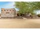 Southwestern style home exterior with stucco walls, wooden beams, and a landscaped walkway at 11305 S 195Th Dr, Buckeye, AZ 85326