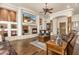 Spacious living room with hardwood floors, fireplace, and large TV at 11305 S 195Th Dr, Buckeye, AZ 85326