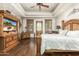 Primary bedroom with wood floors, king bed and access to backyard at 11305 S 195Th Dr, Buckeye, AZ 85326