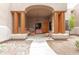 Covered porch with wooden columns, comfortable seating and a chandelier at 11305 S 195Th Dr, Buckeye, AZ 85326