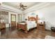 Spacious primary bedroom with wood flooring and a large bed at 11305 S 195Th Dr, Buckeye, AZ 85326