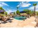 Inviting pool with stone patio and patio umbrellas at 11305 S 195Th Dr, Buckeye, AZ 85326