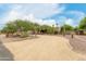 Landscaped front yard with gravel driveway, mature trees and desert landscaping at 11305 S 195Th Dr, Buckeye, AZ 85326