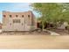 Southwestern style home exterior with stucco walls, wooden beams, and a landscaped walkway at 11305 S 195Th Dr, Buckeye, AZ 85326