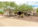 Southwestern style home exterior with stucco walls, wooden beams, and a landscaped walkway at 11305 S 195Th Dr, Buckeye, AZ 85326