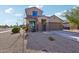 Two-story house with a two-car garage and well-maintained landscaping at 18151 W Carlota Ln, Surprise, AZ 85387