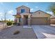 Two-story house with a two-car garage and well-maintained landscaping at 18151 W Carlota Ln, Surprise, AZ 85387