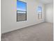 Bedroom with gray carpeting and two windows at 683 E Grayling Rd, San Tan Valley, AZ 85140