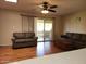 Living room features wood-look floors and sliding glass doors at 10322 W Clair Dr, Sun City, AZ 85351