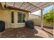 Covered patio with built-in grill and paver stones at 27078 W Yukon Dr, Buckeye, AZ 85396