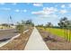 Community sidewalk with landscaping and new homes at 3827 S 97Th Ave, Tolleson, AZ 85353