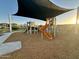 Community playground with shade structure and play equipment at 3827 S 97Th Ave, Tolleson, AZ 85353