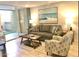 Living room with gray sofa and ocean-themed art at 7625 E Camelback Rd # B108, Scottsdale, AZ 85251