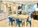 Kitchen and dining area with a farmhouse table and blue chairs at 7625 E Camelback Rd # B108, Scottsdale, AZ 85251
