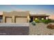 Two-car garage and front entrance of a charming, stucco home at 20324 W Melanie Dr, Wittmann, AZ 85361