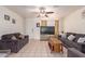 Living room with two dark gray sofas, a coffee table, and a large TV at 8151 W Clarendon Ave, Phoenix, AZ 85033