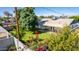 Backyard with covered patio, grassy area, and mature trees at 8151 W Clarendon Ave, Phoenix, AZ 85033