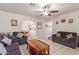 Living room with dark gray sofas, a coffee table, and views into the kitchen and dining area at 8151 W Clarendon Ave, Phoenix, AZ 85033