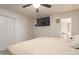 Main bedroom with a large TV and en-suite bathroom access at 8151 W Clarendon Ave, Phoenix, AZ 85033