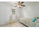 Cozy bedroom featuring a twin bed, ceiling fan, and glass-top table at 8151 W Clarendon Ave, Phoenix, AZ 85033